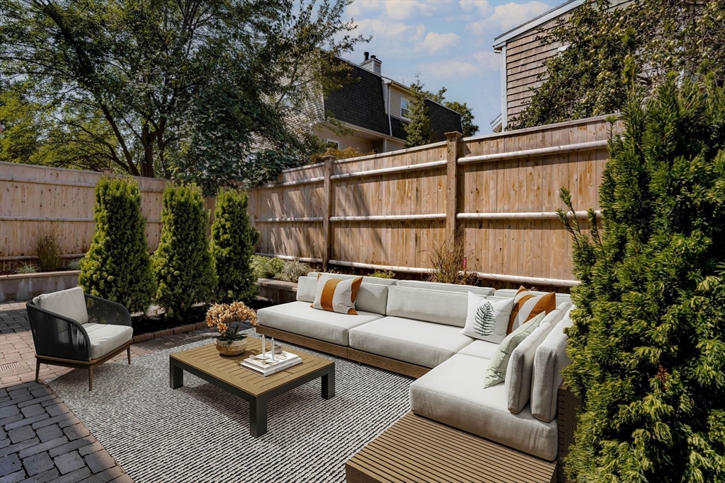 27 Summit Avenue, Unit 2 Brookline, MA 02446 - Photo 33 of 34 a roof deck with couch and outdoor seating
