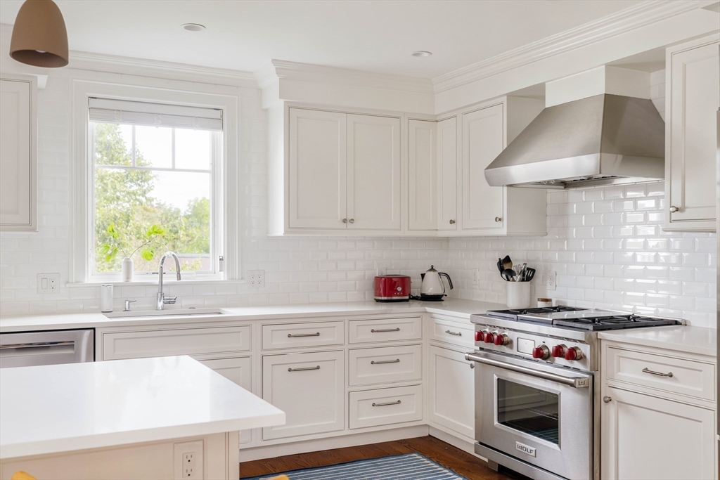 27 Summit Avenue, Unit 2 Brookline, MA 02446 - Photo 8 of 34 a kitchen with cabinets appliances a sink and a window