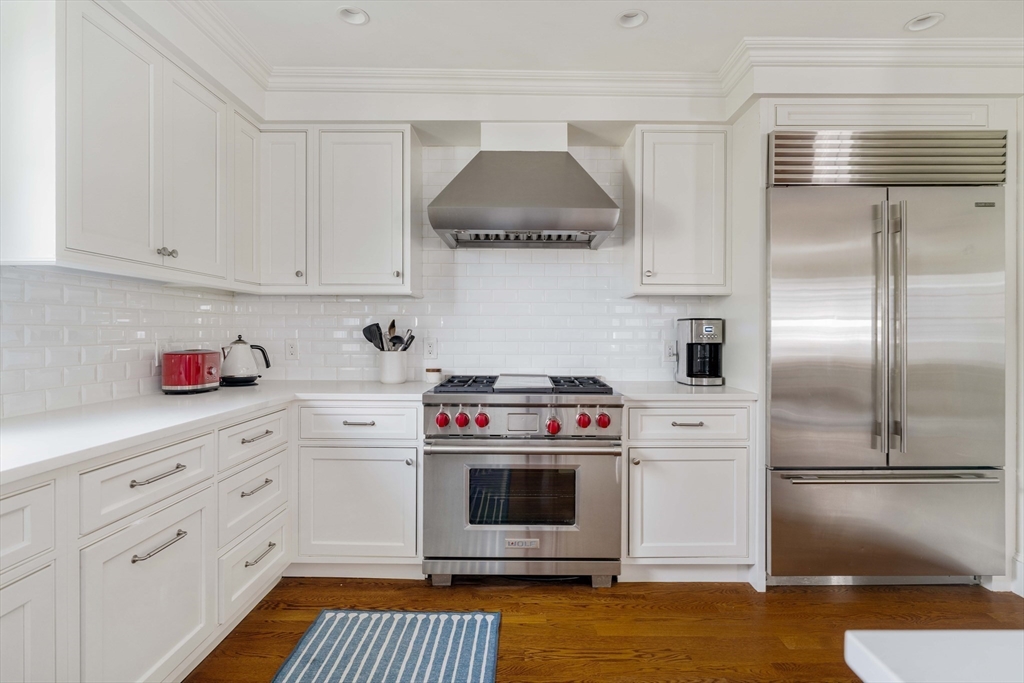 27 Summit Avenue, Unit 2 Brookline, MA 02446 - Photo 9 of 34 a kitchen with stainless steel appliances a stove and a refrigerator