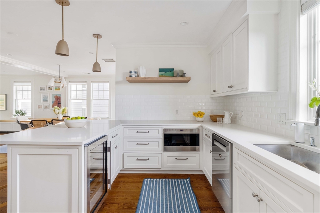 27 Summit Avenue, Unit 2 Brookline, MA 02446 - Photo 10 of 34 a kitchen with a sink a stove and cabinets