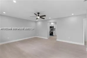 an empty room with a empty space and a ceiling fan