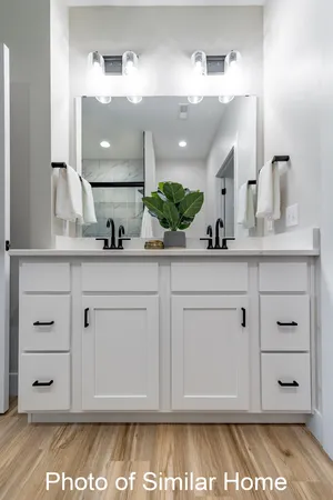 a bathroom with a sink vanity granite and a mirror