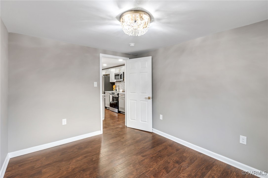 9531 Reams Road Chesterfield, VA 23236 - Photo 25 of 34 a view of a chandelier fan and wooden floor