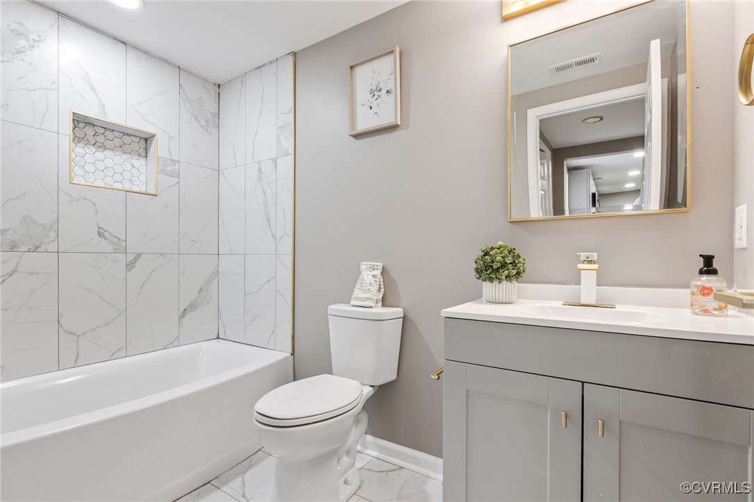 9531 Reams Road Chesterfield, VA 23236 - Photo 27 of 34 a bathroom with a toilet a sink a mirror a bathtub and vanity