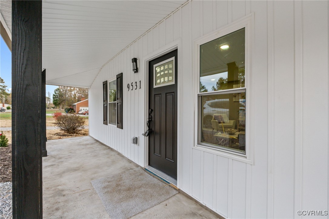 9531 Reams Road Chesterfield, VA 23236 - Photo 5 of 34 a view of a hallway with wooden floor and a living room