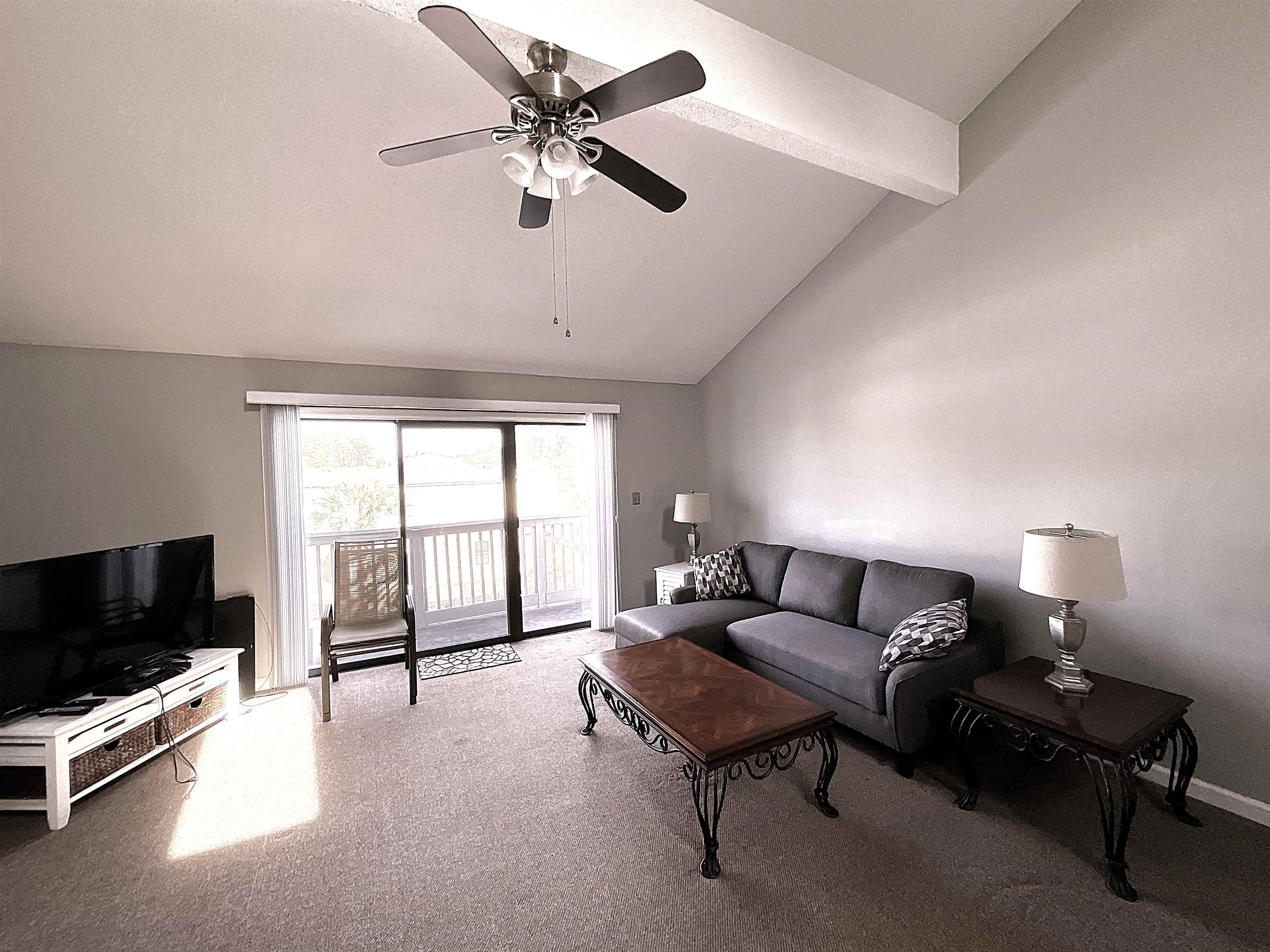 1880 Colony Drive, Unit 11O Surfside Beach, SC 29575 - Photo 13 of 17 Living room with beam ceiling, high vaulted ceiling, light colored carpet, and ceiling fan