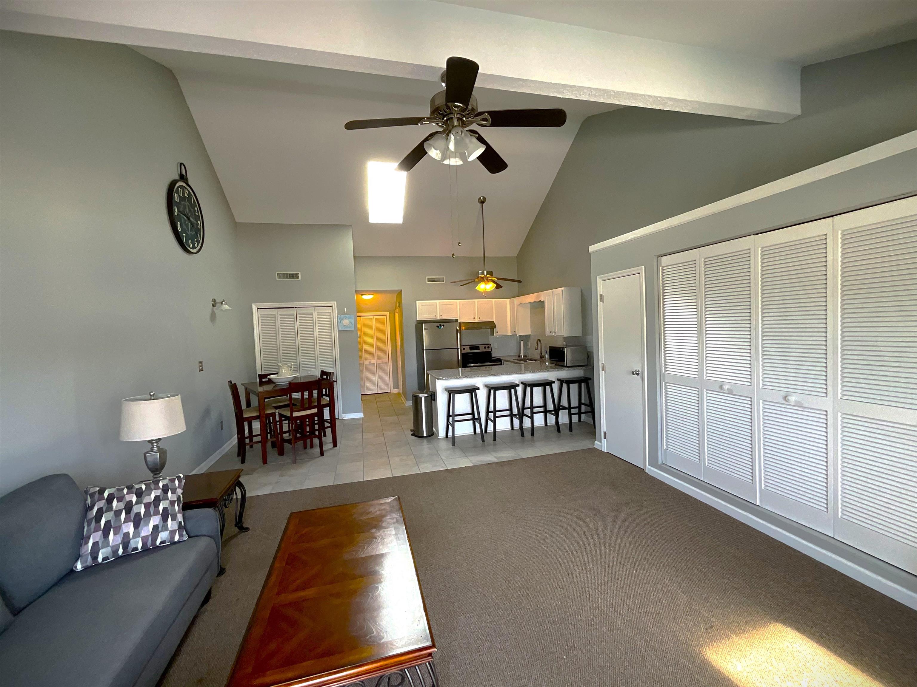 1880 Colony Drive, Unit 11O Surfside Beach, SC 29575 - Photo 17 of 17 Living room featuring high vaulted ceiling, ceiling fan, and light colored carpet