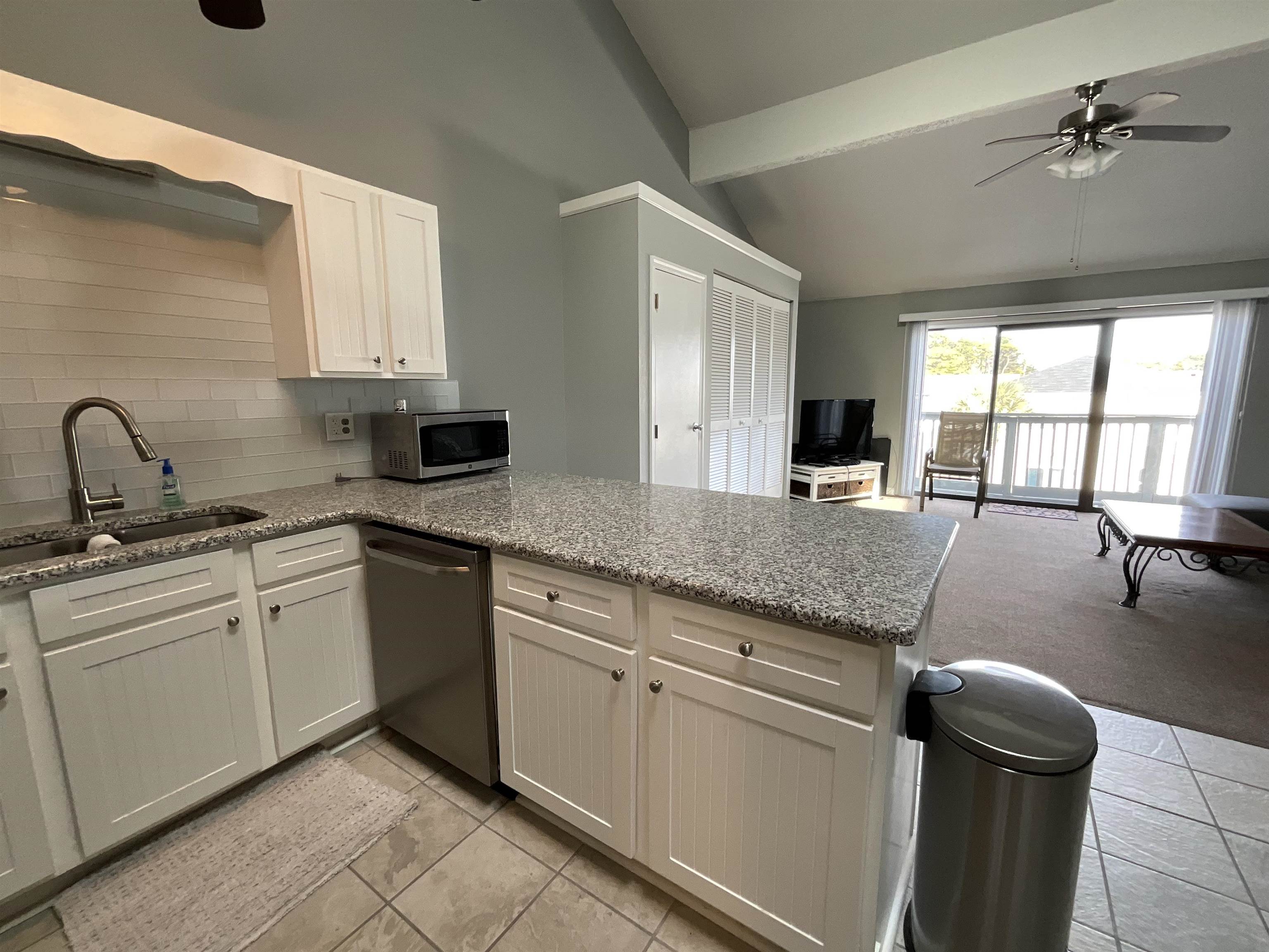 1880 Colony Drive, Unit 11O Surfside Beach, SC 29575 - Photo 5 of 17 Kitchen with a ceiling fan, light stone counters, appliances with stainless steel finishes, and a peninsula