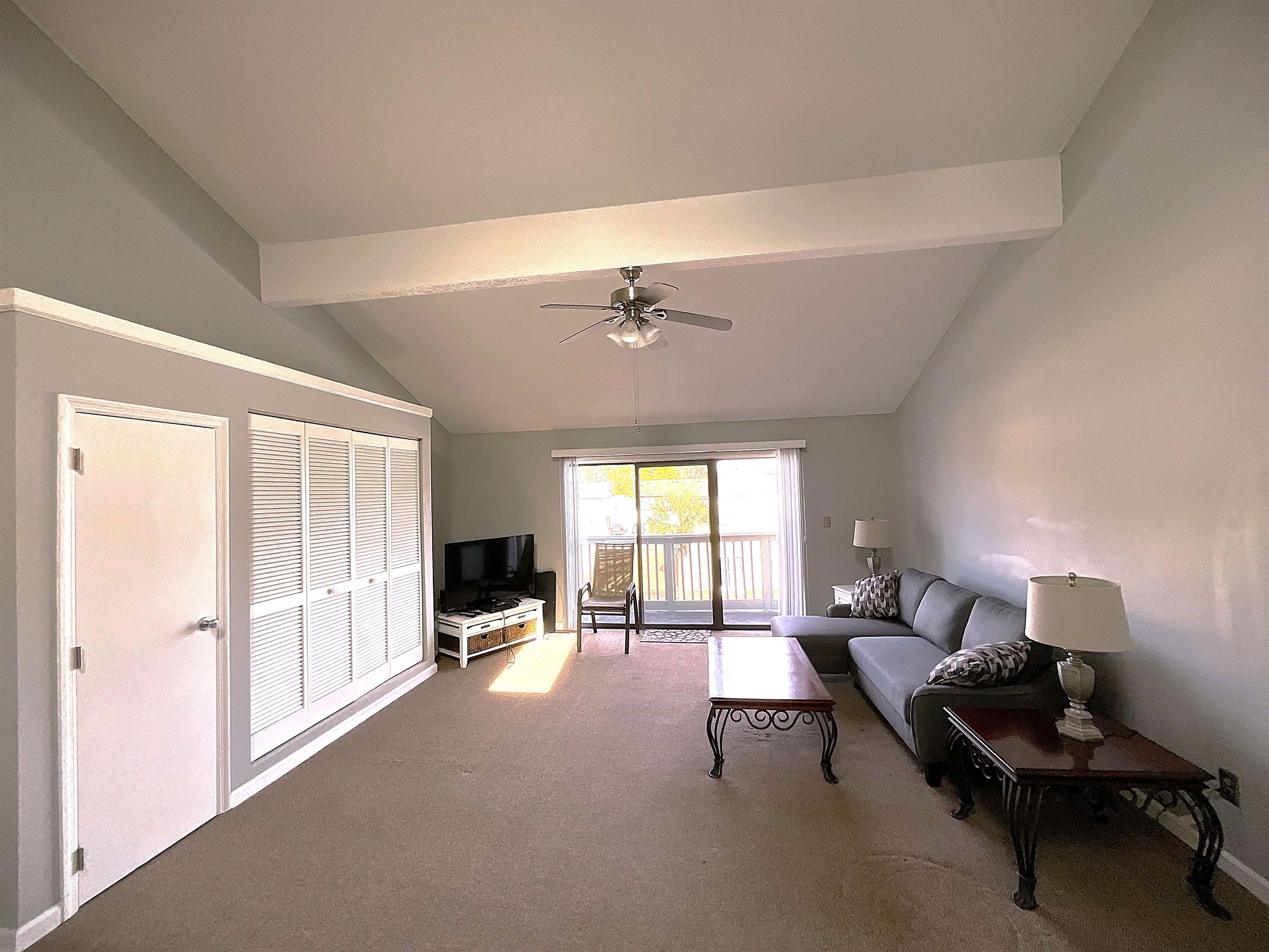 1880 Colony Drive, Unit 11O Surfside Beach, SC 29575 - Photo 8 of 14 Carpeted living area featuring beam ceiling and ceiling fan