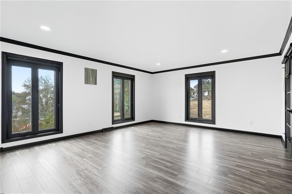 2460 Nicholson Road Sewickley, PA 15143 - Photo 20 of 50 a view of an empty room with wooden floor and a window
