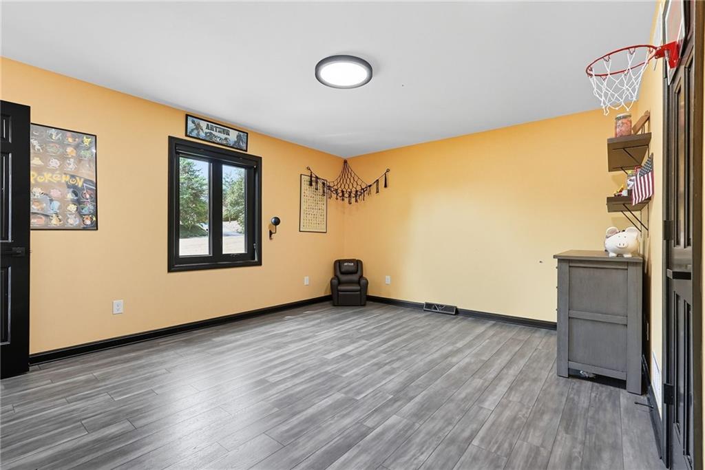 2460 Nicholson Road Sewickley, PA 15143 - Photo 29 of 50 a view of an empty room with wooden floor and a window