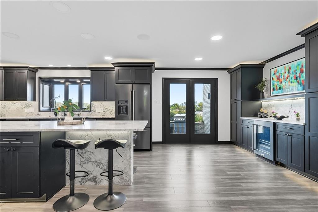 2460 Nicholson Road Sewickley, PA 15143 - Photo 10 of 50 a kitchen with stainless steel appliances granite countertop a kitchen island hardwood floor sink stove and granite counter top
