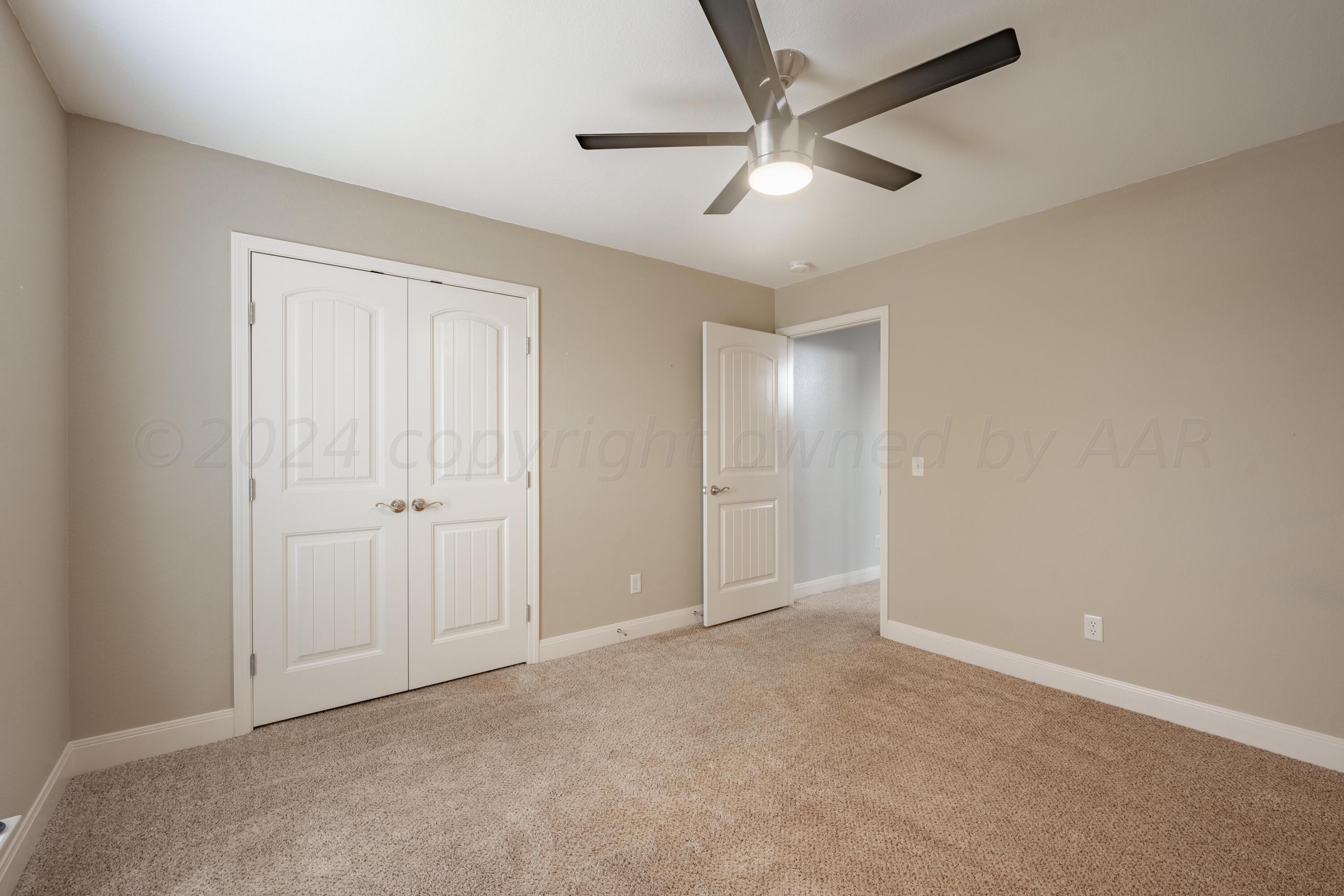 4512 Ross Street Amarillo, TX 79118 - Photo 14 of 24 an empty room with chandelier fan
