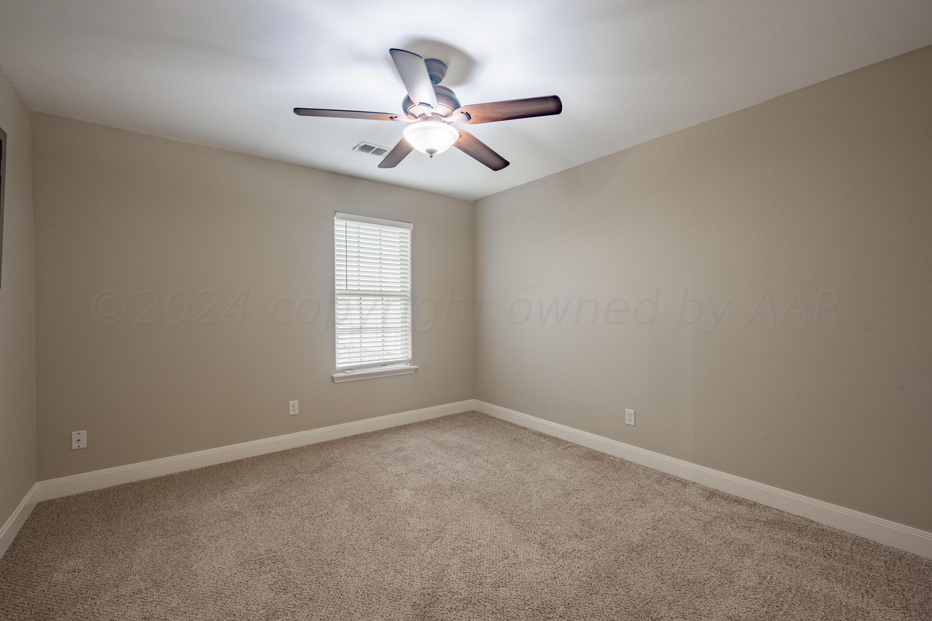 4512 Ross Street Amarillo, TX 79118 - Photo 16 of 24 an empty room with a window and a fan
