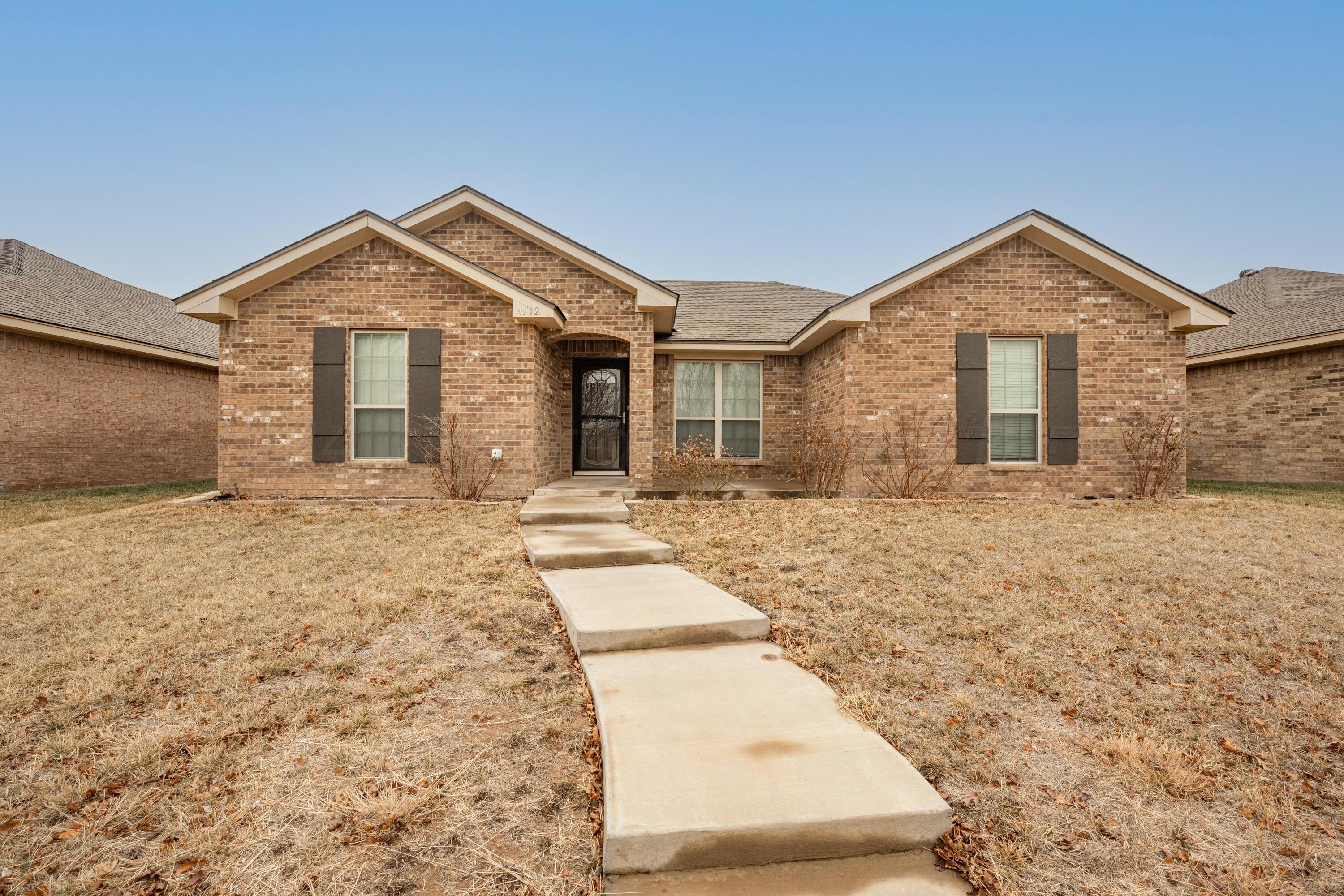 4512 Ross Street Amarillo, TX 79118 - Photo 18 of 24 a view of a house with a yard and garage
