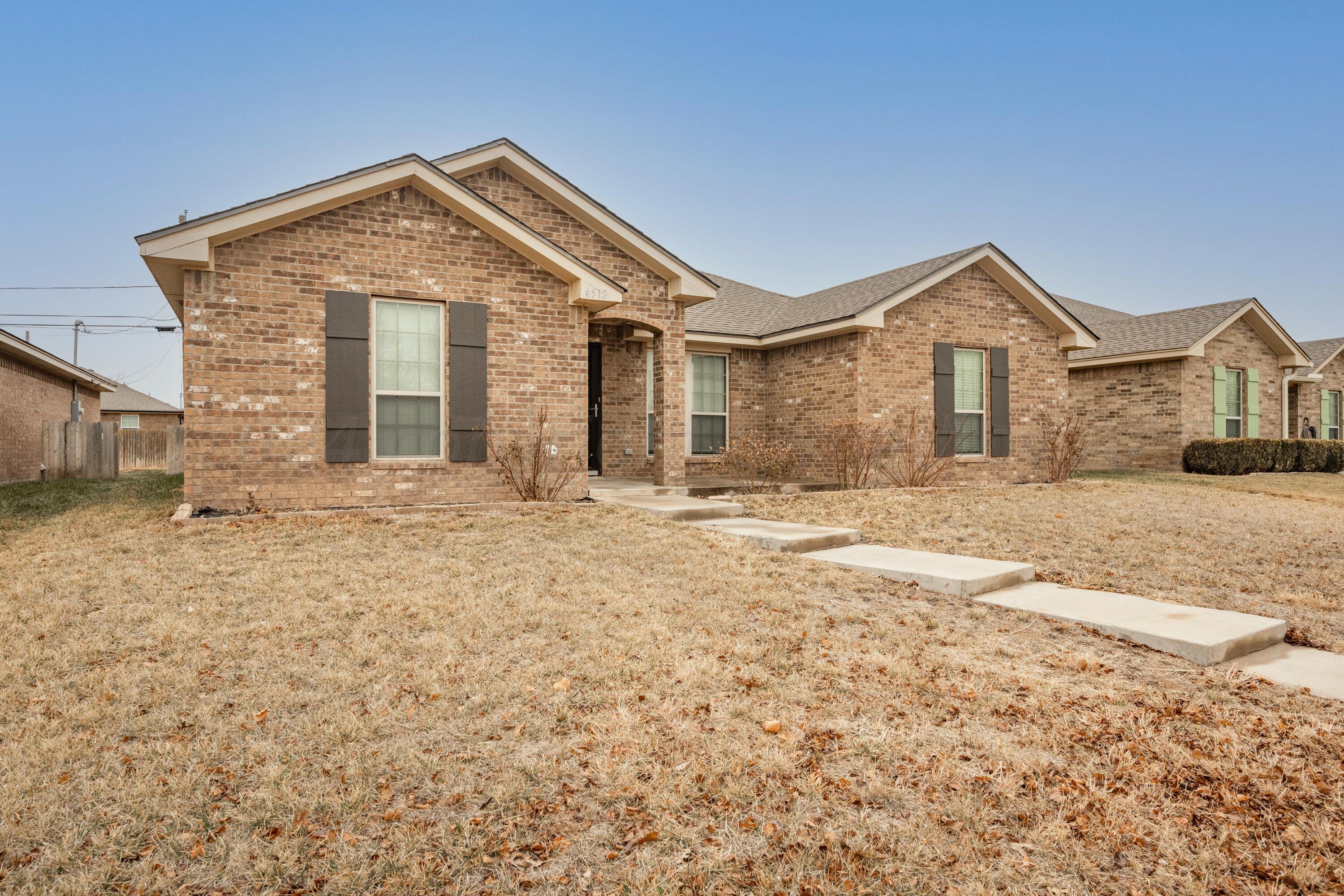 4512 Ross Street Amarillo, TX 79118 - Photo 19 of 24 a front view of a house with a yard
