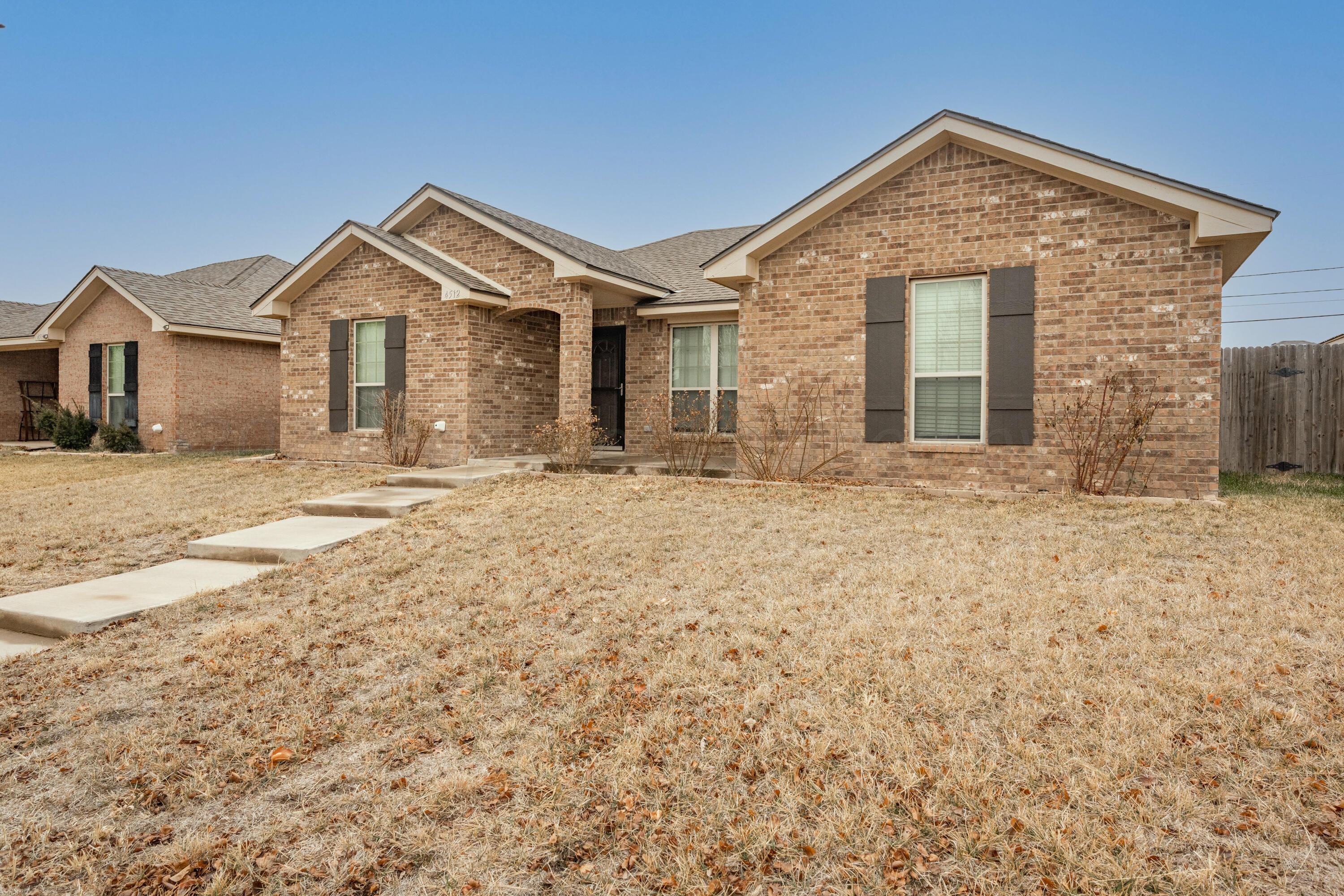 4512 Ross Street Amarillo, TX 79118 - Photo 20 of 24 a front view of a house with a yard
