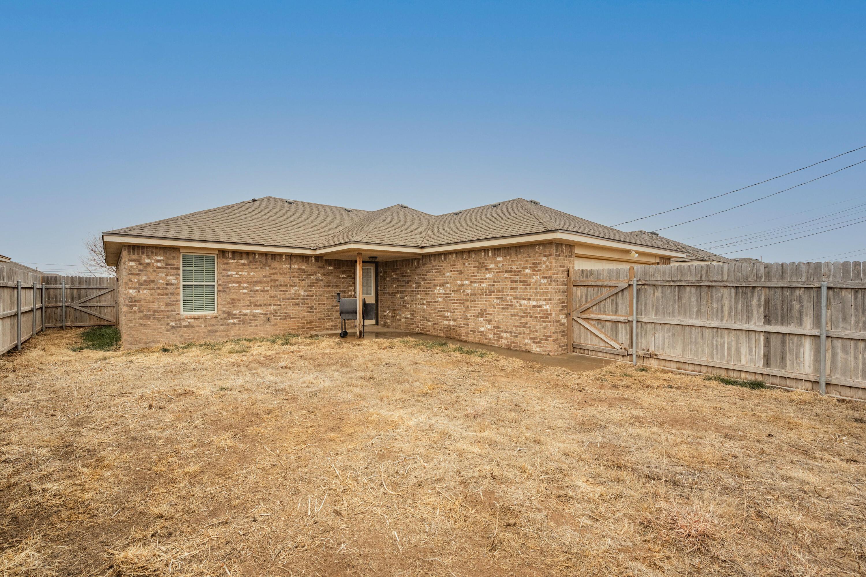 4512 Ross Street Amarillo, TX 79118 - Photo 22 of 24 a view of a backyard with a fence