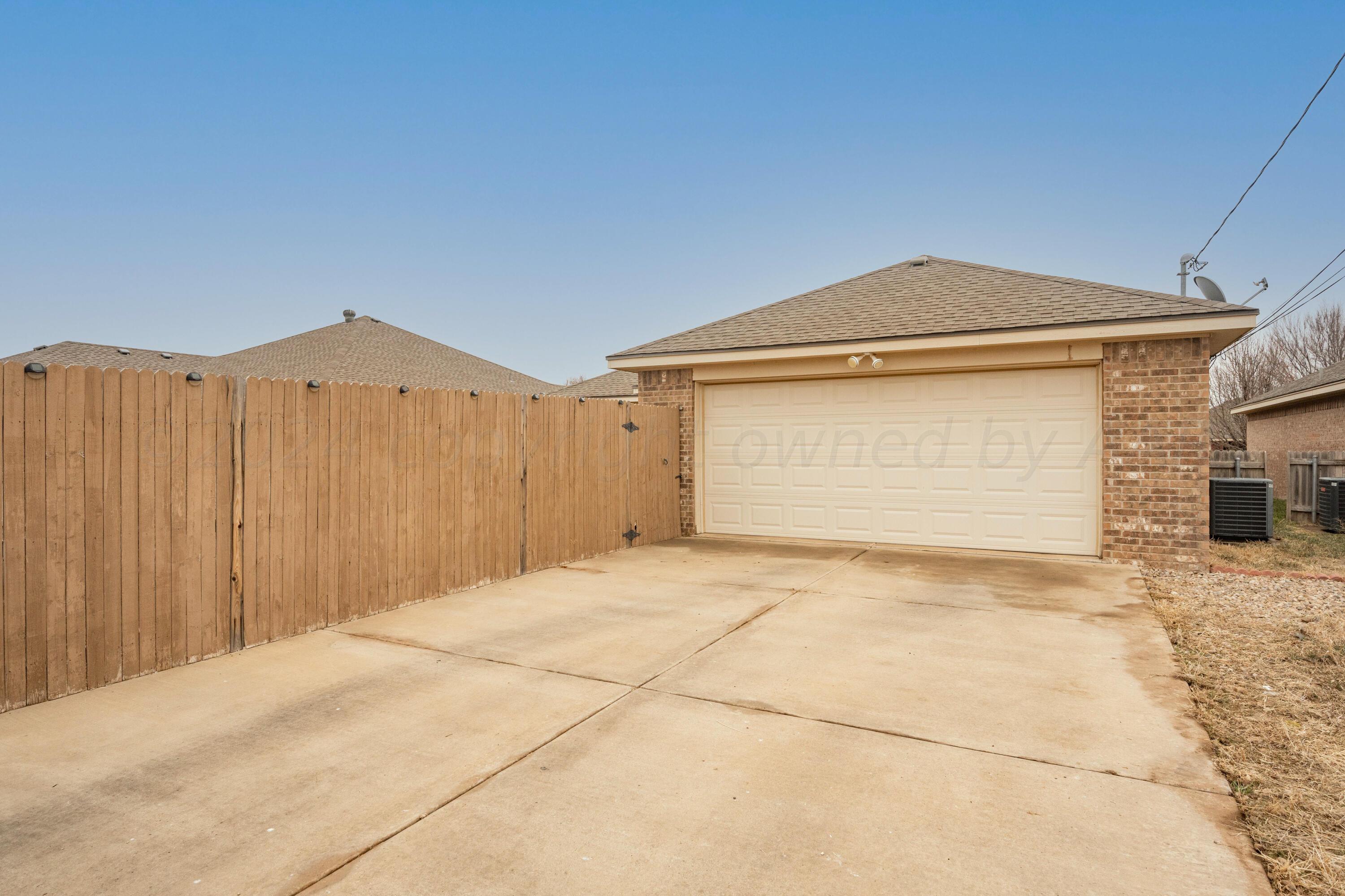 4512 Ross Street Amarillo, TX 79118 - Photo 24 of 24 a front view of a house with a yard and garage