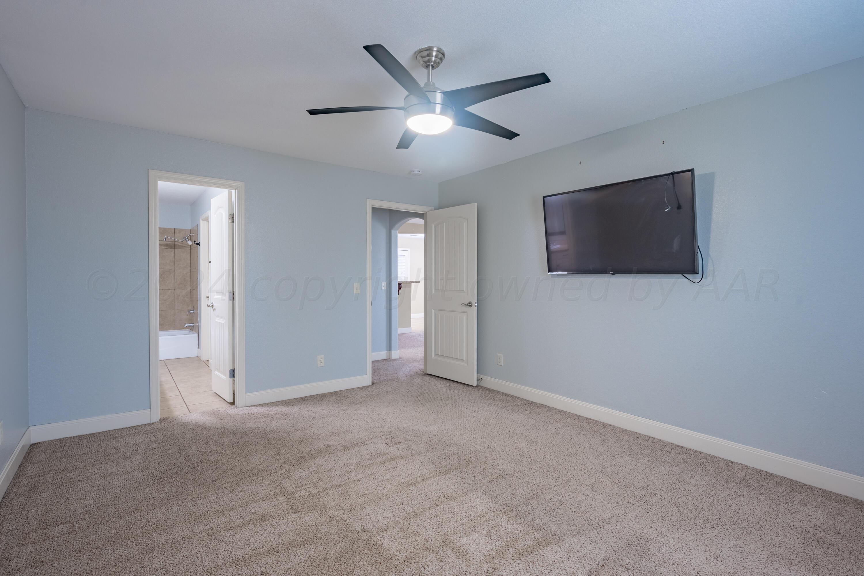 4512 Ross Street Amarillo, TX 79118 - Photo 9 of 24 a view of an empty room with a ceiling fan and window
