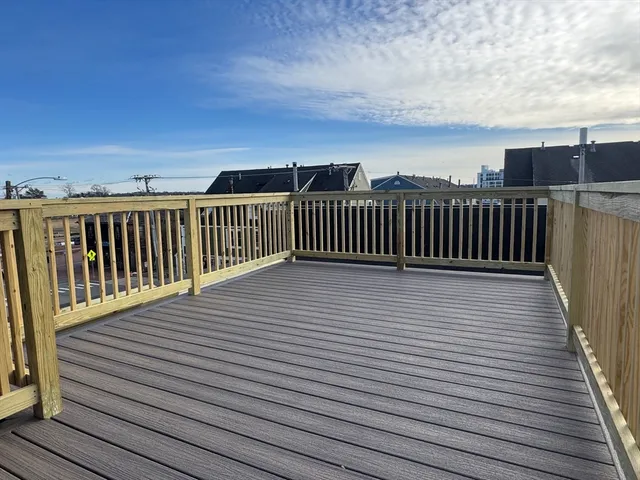 a view of a roof with wooden floor and fence