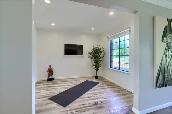 a view of a livingroom with wooden floor and a window