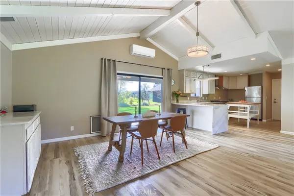 a dining room with furniture and wooden floor