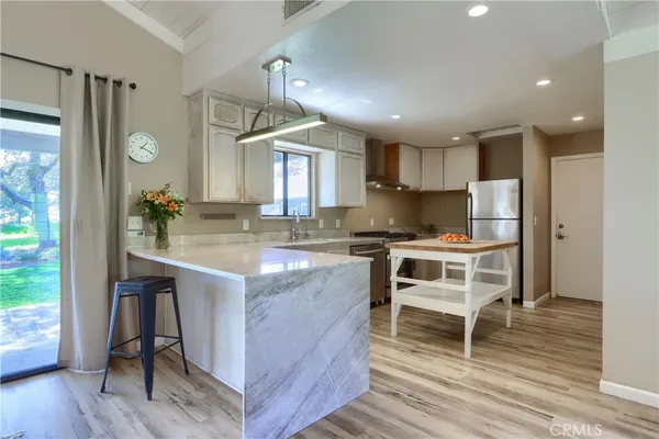 a stove top oven sitting inside of a kitchen