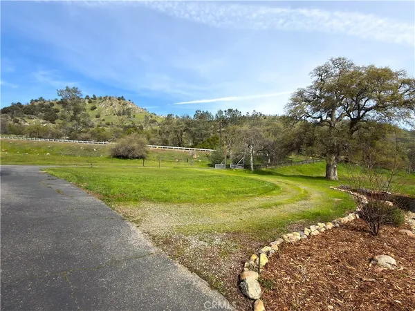 an aerial view of a house with garden space and street view