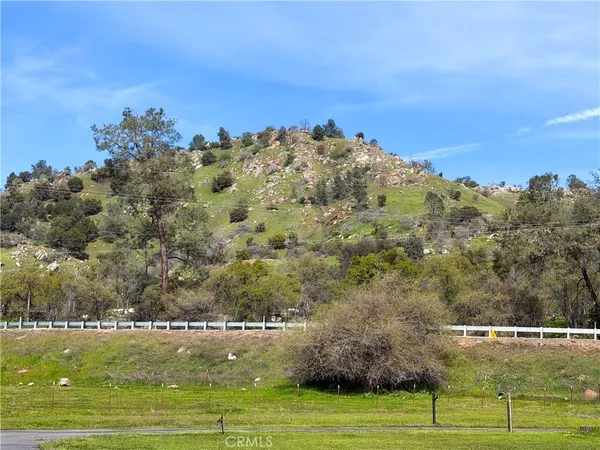 an aerial view of a house with garden space and street view