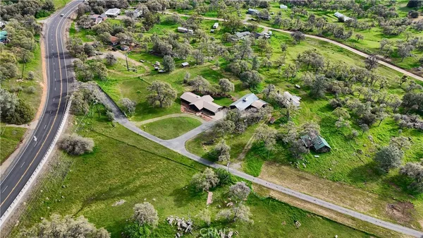 a view of a lush green field with mountains in the background