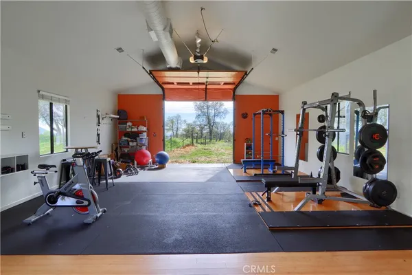 a room with gym equipment and large mirror
