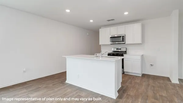 a kitchen with granite countertop white cabinets and black appliances