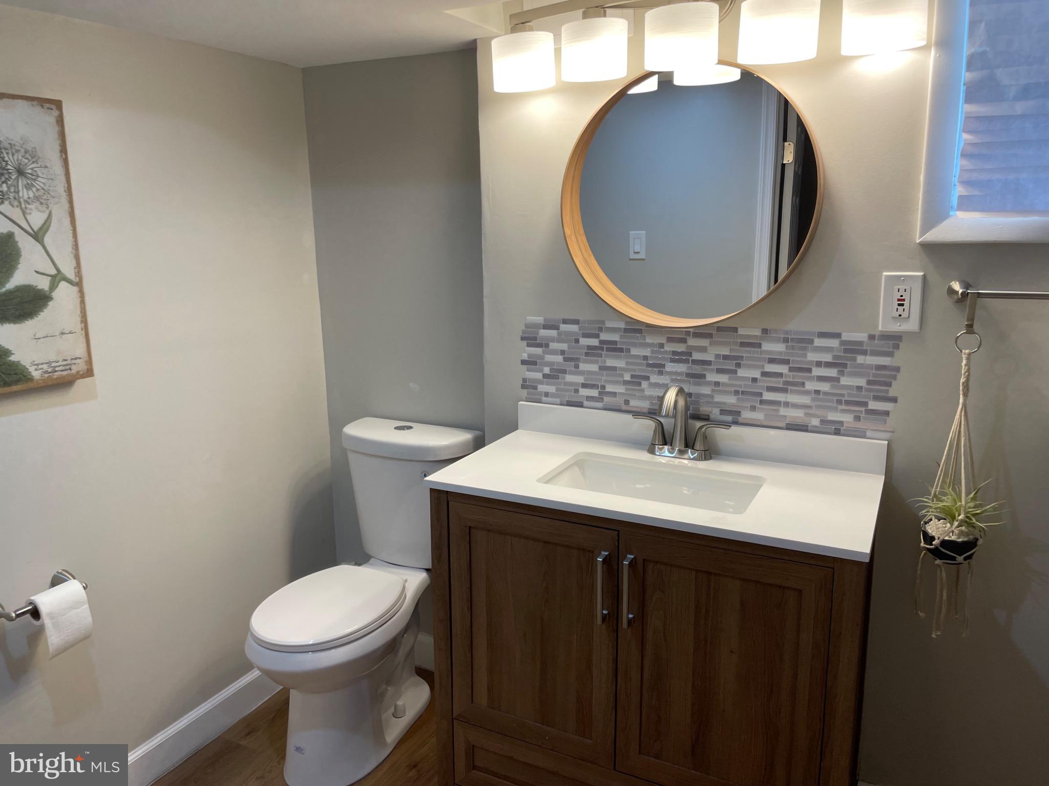 2301 Mosher Street Baltimore, MD 21216 - Photo 22 of 30 a bathroom with a sink and a mirror