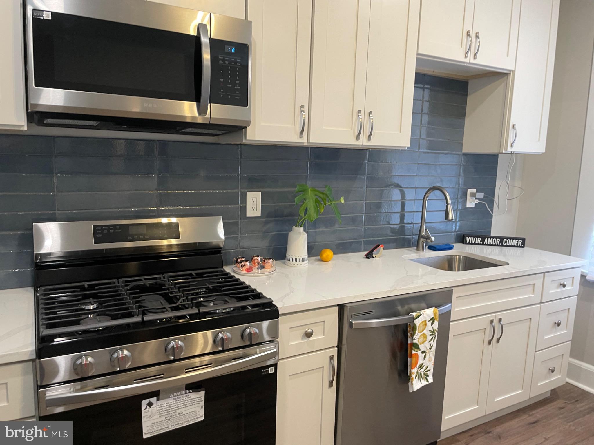 2301 Mosher Street Baltimore, MD 21216 - Photo 3 of 30 a kitchen with appliances a sink and cabinets