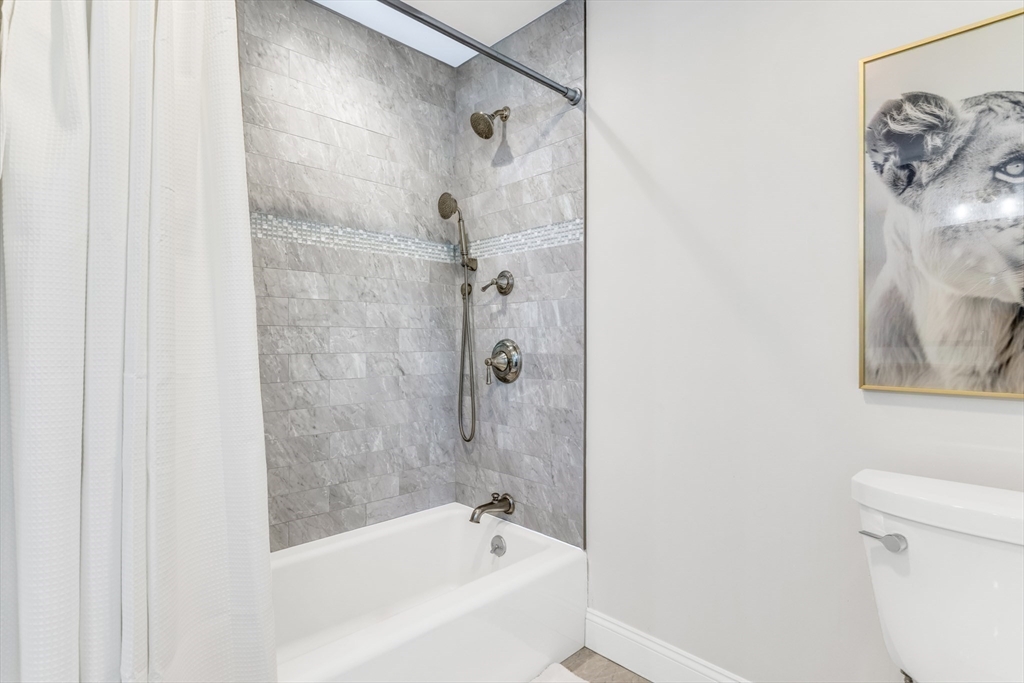 85 Old Farm Road Milton, MA 02186 - Photo 23 of 42 a bathroom with a bathtub and a shower