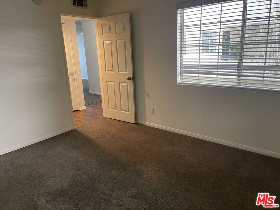 5530 Owensmouth Avenue, Unit 223 Woodland Hills, CA 91367 - Photo 15 of 21 an empty room with windows