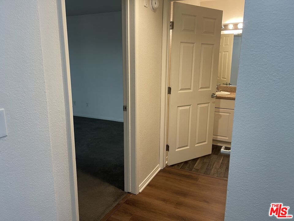 5530 Owensmouth Avenue, Unit 223 Woodland Hills, CA 91367 - Photo 16 of 21 an empty room with wooden floor