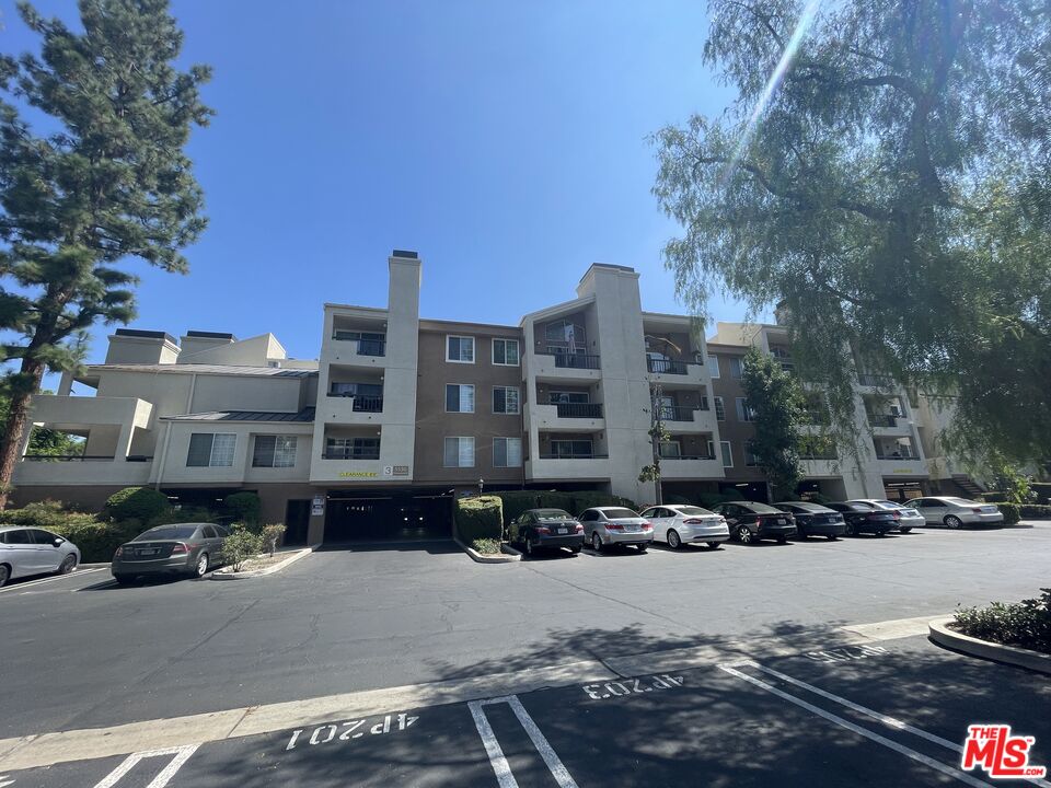 5530 Owensmouth Avenue, Unit 223 Woodland Hills, CA 91367 - Photo 2 of 21 a city street lined with buildings and cars