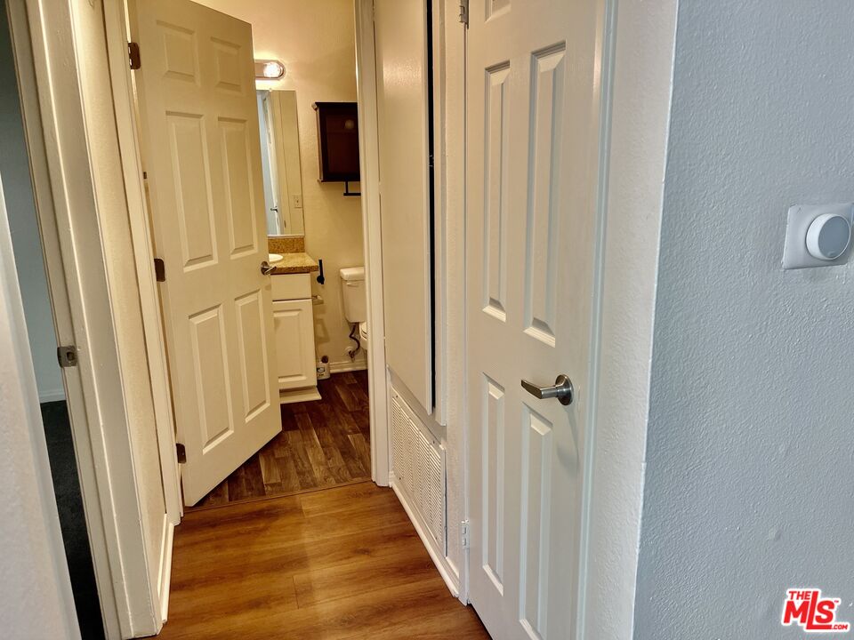5530 Owensmouth Avenue, Unit 223 Woodland Hills, CA 91367 - Photo 9 of 21 a view of a hallway with a wooden door