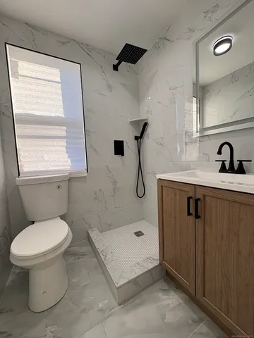 a bathroom with a sink toilet and shower