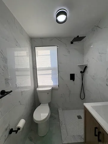 a bathroom with a toilet sink and shower