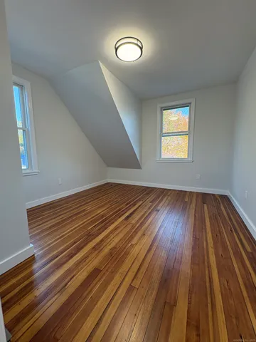 a view of a room with wooden floor and a window