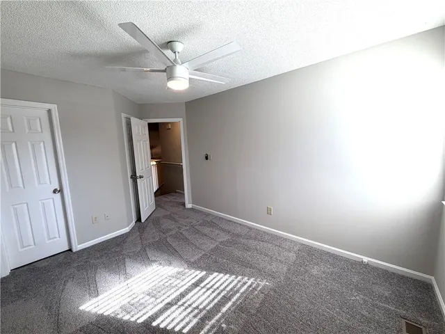 a view of a livingroom with a ceiling fan and window
