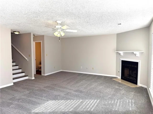 a view of an empty room with a fireplace