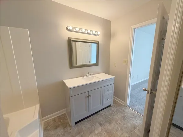 a bathroom with a sink a mirror and a vanity