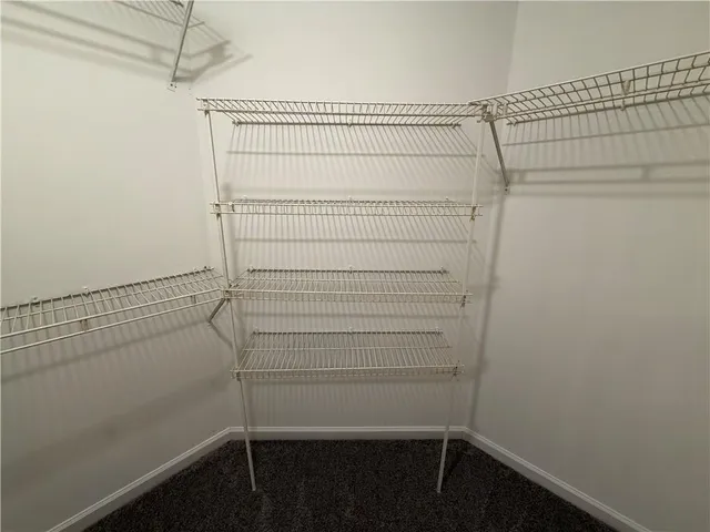 a view of walk in closet with clothes