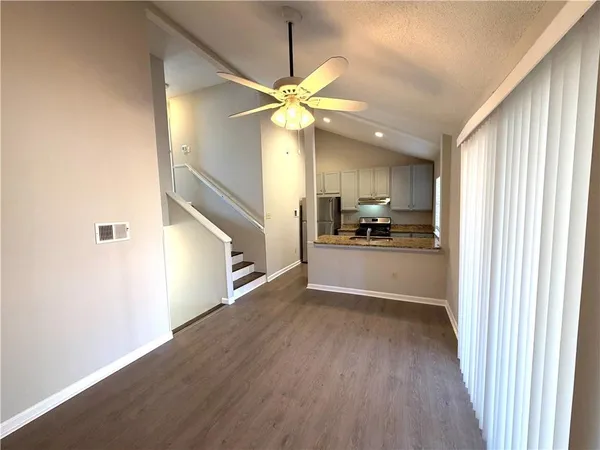 a view of a kitchen with an empty space and a ceiling fan
