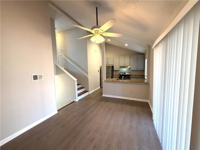 a view of a kitchen with an empty space and a ceiling fan