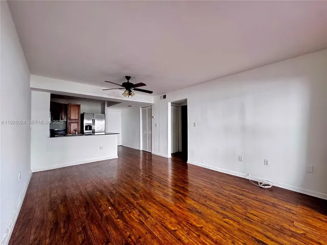 a view of a kitchen with wooden floor and a sink
